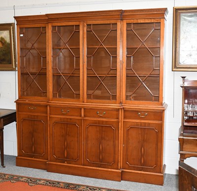 Lot 1257 - A Reproduction Yew Wood Breakfront Bookcase,...