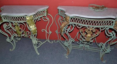 Lot 601 - A pair of green painted cast iron and metal mounted console tables with white marble tops