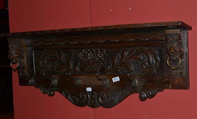 Lot 602 - Carved oak wall mounted coat rack