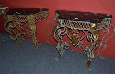 Lot 604 - A pair of cast iron and metal mounted console tables with black marble tops