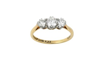 Lot 2387 - A Diamond Three Stone Ring the graduated round...
