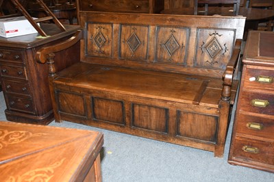 Lot 1361 - A 20th Century Carved Oak Settle, with four...
