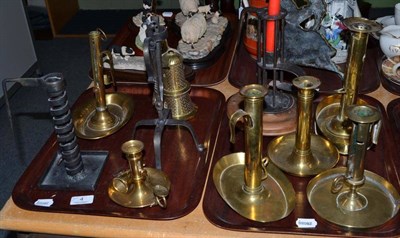 Lot 4 - A collection of mostly 19th century brass chambersticks, most with adjusters (on two trays)