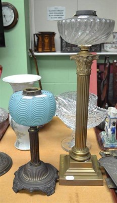 Lot 45 - A Victorian brass column oil lamp with wrythen glass oil well; and another smaller with a blue...