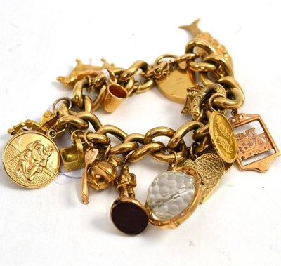 Lot 85 - A 9ct gold curb and lock bracelet, alternate engraved links, hung with fifteen charms, some...