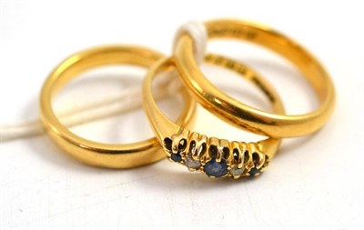 Lot 87 - An 18ct gold sapphire and diamond ring and two 18ct gold band rings