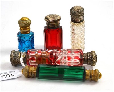 Lot 103 - A Victorian ruby flash double scent bottle, green tinted double scent, silver topped scent with...