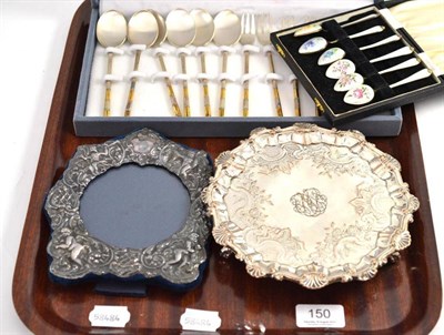 Lot 150 - Silver mounted photograph frame, enamel decorated teaspoons, plated card tray and a cased set...