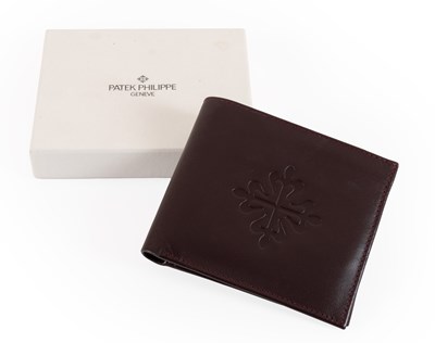 Lot 1045 - Patek Philippe Geneve Burgundy Leather Wallet,...
