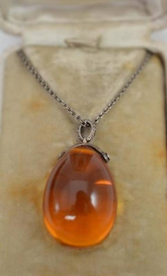 Lot 189 - Amber pendant and chain set with diamond shoulders, in fitted case