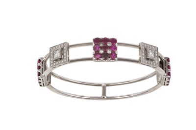 Lot 2128 - A Ruby and Diamond Hinged Bangle three ruby...