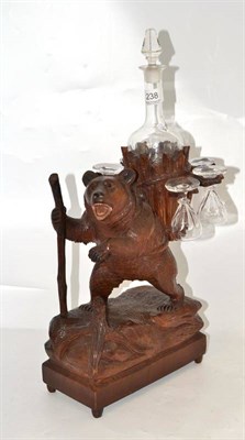 Lot 238 - A Black Forest liqueur set, modelled as a bear holding a staff in his paw and a basket on his back