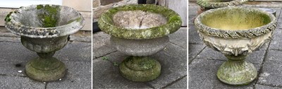 Lot 243 - Three Composition Stone Garden Urns, in...