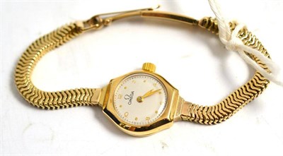 Lot 269 - A lady's 9ct gold wristwatch, signed Omega, 1949, lever movement, silvered dial with dot and Arabic