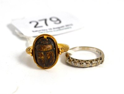 Lot 279 - A nine stone ring and a scarab ring