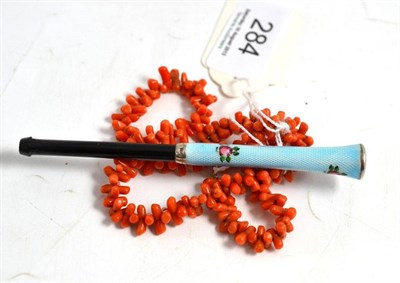 Lot 284 - A coral necklace and an enamelled cigarette holder