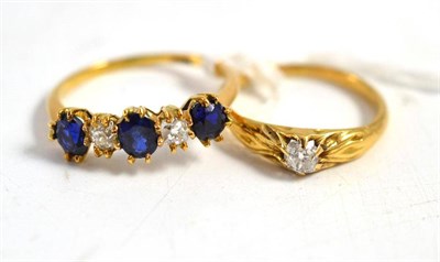 Lot 302 - A diamond and solitaire ring and a sapphire and diamond five stone ring