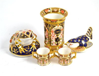 Lot 310 - Royal Crown Derby frog paperweight, bird, two miniature loving cups, and a spill vase on four...