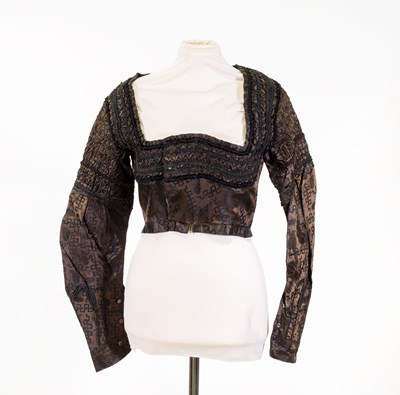 Lot 2057 - 19th Century Green Silk Spencer woven in black...