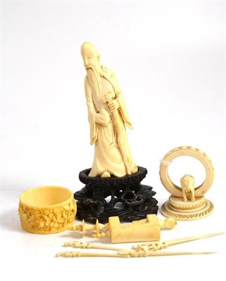 Lot 365 - An ivory needlework clamp, an Indian ivory elephant carved stand with cocktail sticks, carved ivory