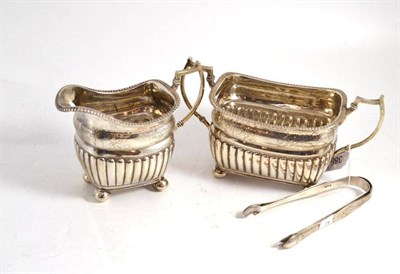 Lot 388 - Georgian silver sugar and cream and two pairs of tongs