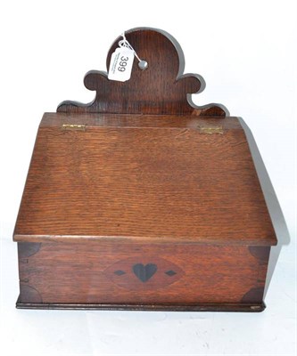 Lot 399 - An oak candle box with hinged lid