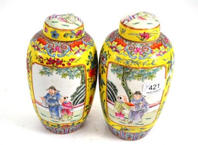 Lot 421 - A pair of Chinese porcelain baluster vases and domed covers, Qianlong reign marks but not of...