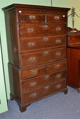 Lot 489 - An 18th century oak and walnut crossbanded chest on chest, the cavetto cornice above an arrangement