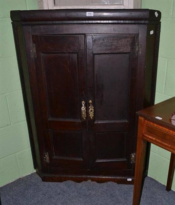 Lot 498 - An oak corner cupboard