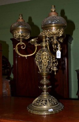 Lot 510 - A brass three branch oil lamp converted for electricity, height 67cm, by repute housed in...