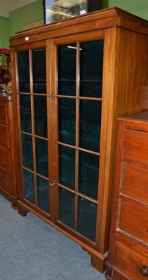 Lot 512 - A walnut glazed two door china cabinet with a velvet lined interior