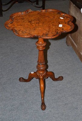 Lot 531 - A tripod table with a walnut shaped top and an oak tripod base