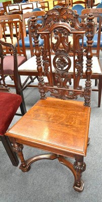 Lot 549 - A carved oak hall chair in 17th century style