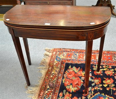 Lot 558 - A 19th century mahogany fold over card table