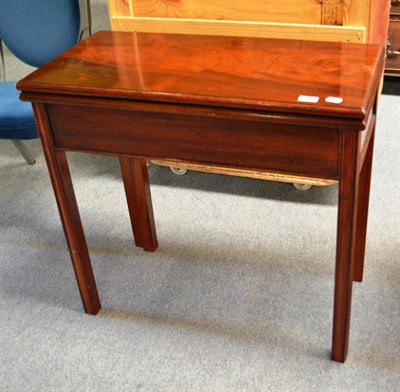 Lot 561 - A George III Mahogany foldover tea table, 3rd quarter 18th century, of rectangular form with square