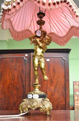 Lot 577 - Spelter cherub lamp and shade