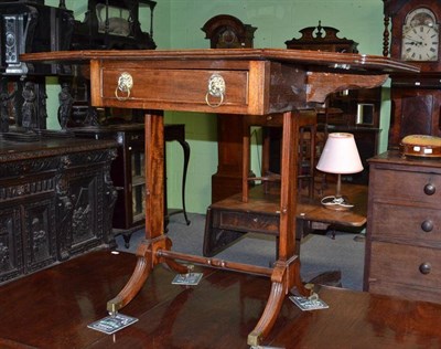 Lot 579 - Regency mahogany drop-leaf work table with lion mask ring handles