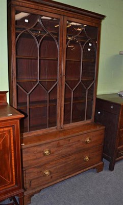 Lot 593 - A 19th century mahogany glazed bookcase on a later two drawer base