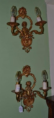 Lot 610 - A pair of 20th century ormolu two branch wall lights decorated with putti and shells