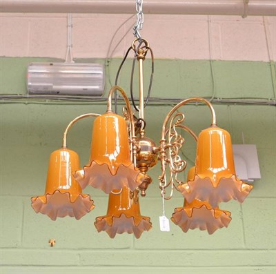 Lot 613 - A Victorian style brass light fitting with five amber glass shades