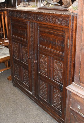 Lot 1317 - A Carved Oak Two Door Cupboard, composed of...