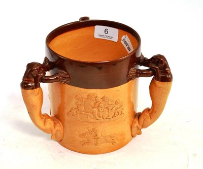 Lot 6 - Doulton Lambeth salt glazed harvest three handled cup, with greyhound handles