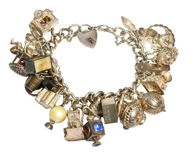 Lot 436 - A Silver Charm Bracelet, suspending...