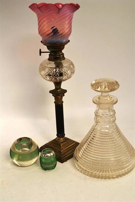 Lot 31 - A step cut decanter, two match strikers and an oil lamp