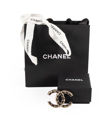 Lot 1052 - Chanel Turn Lock CC Brooch, with black leather...