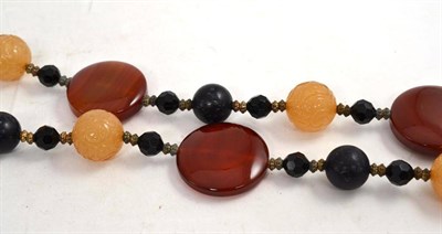 Lot 71 - A multi stone necklace, including cornelian, onyx and carved yellow beads