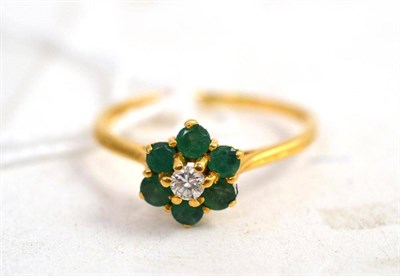 Lot 78 - An 18ct gold diamond and emerald cluster ring