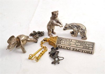 Lot 83 - A silver reproduction medieval style calendar, two silver bears, a novelty articulated elephant and