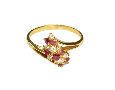 Lot 524 - An 18 Carat Gold Ruby and Diamond Cluster Ring,...