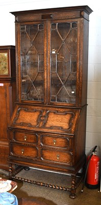 Lot 1285 - A 1920s Oak Bureau Bookcase, with astragal...
